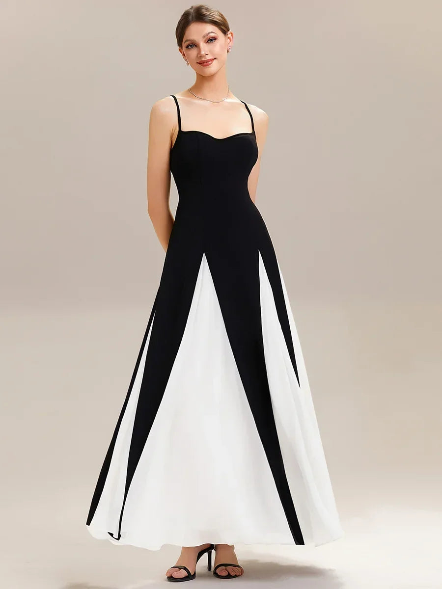 Woman wearing an elegant black and white A-line evening gown with a sweetheart neckline.