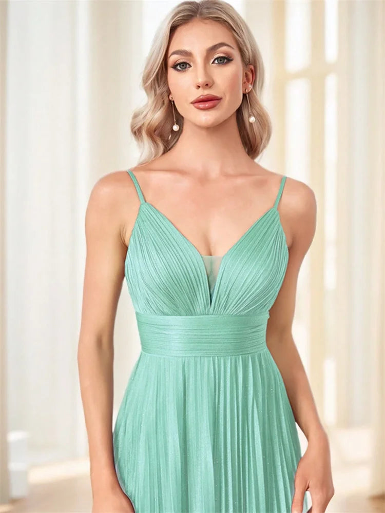 Woman wearing an elegant mint green chiffon A-line evening gown with a deep V-neck.