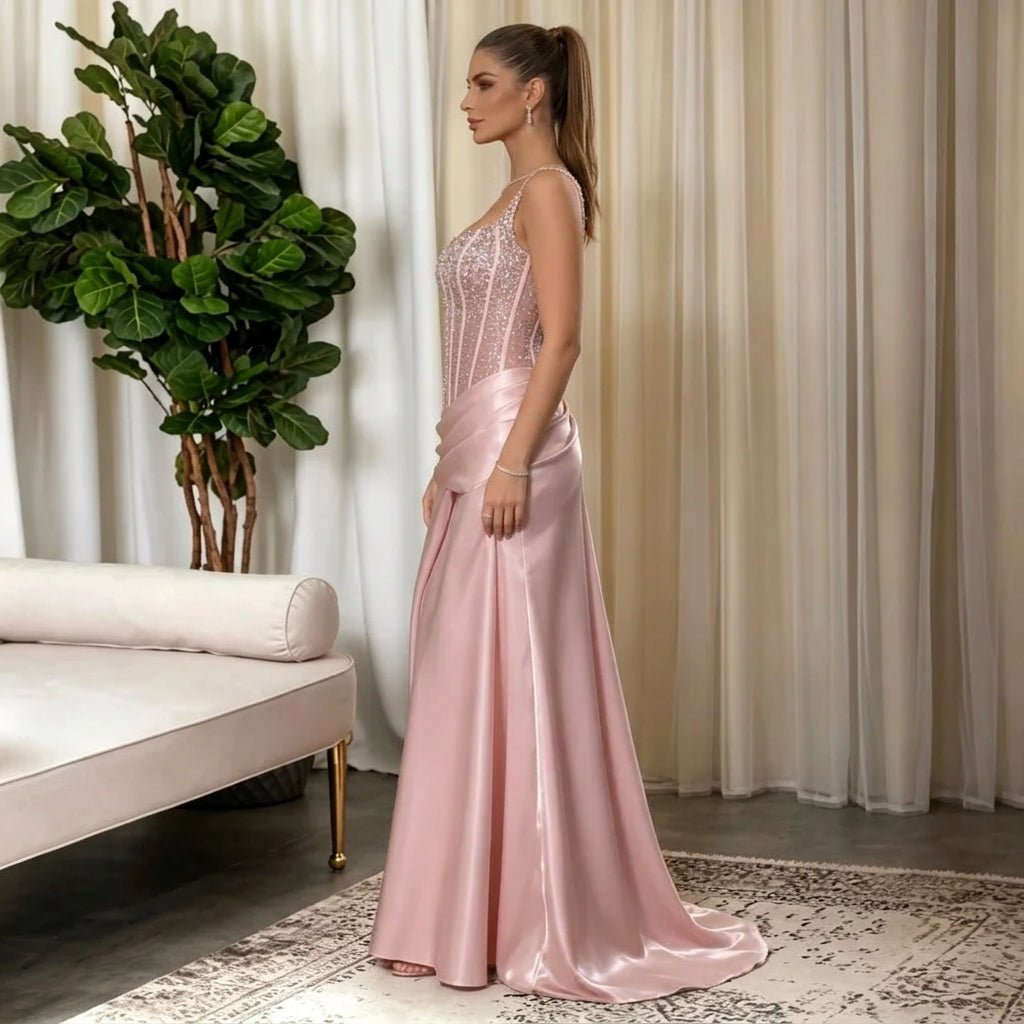 Woman wearing an AliExpress spaghetti strap corset satin evening gown in pink.