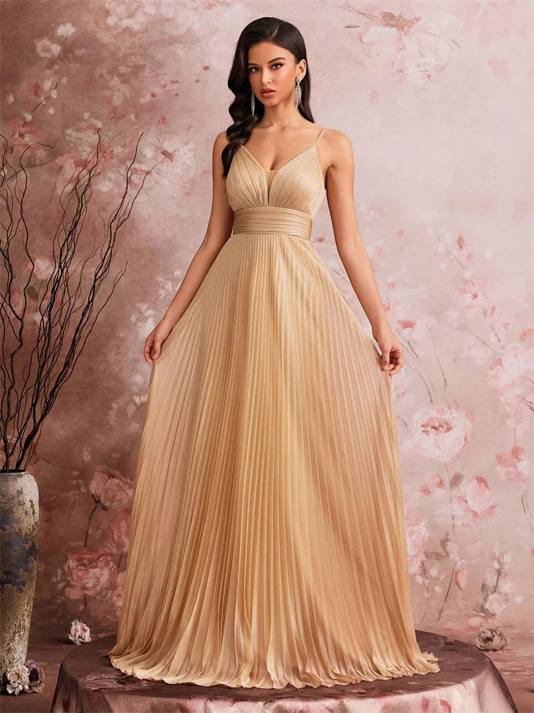 Woman wearing an elegant Dream Designs Boutique deep V-neck pleated chiffon A-line evening gown.