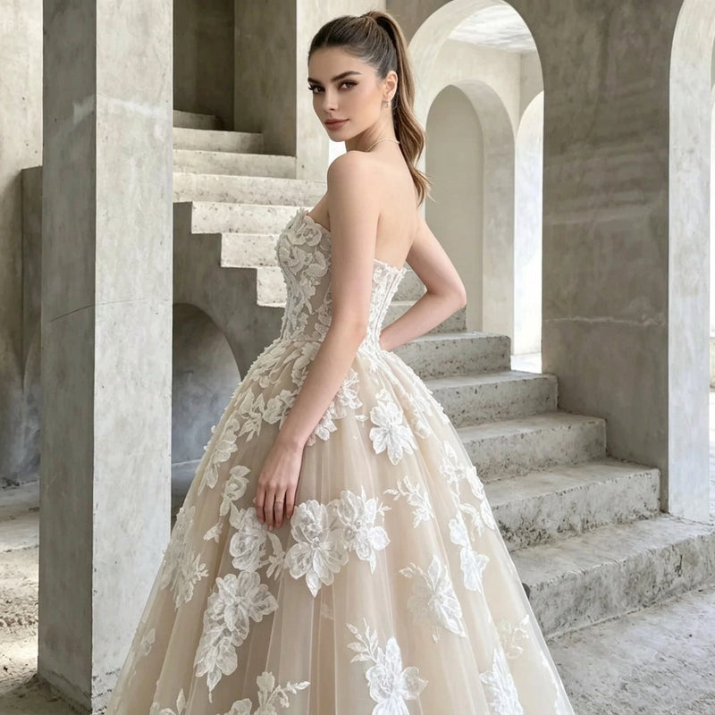 Woman wearing a strapless floral applique A-line bridal gown by AliExpress in a concrete setting.