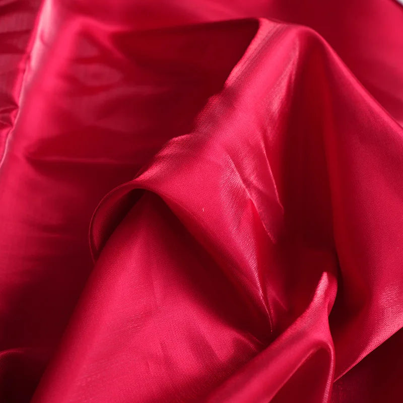 Red satin fabric texture for an AliExpress spaghetti strap corset evening gown.