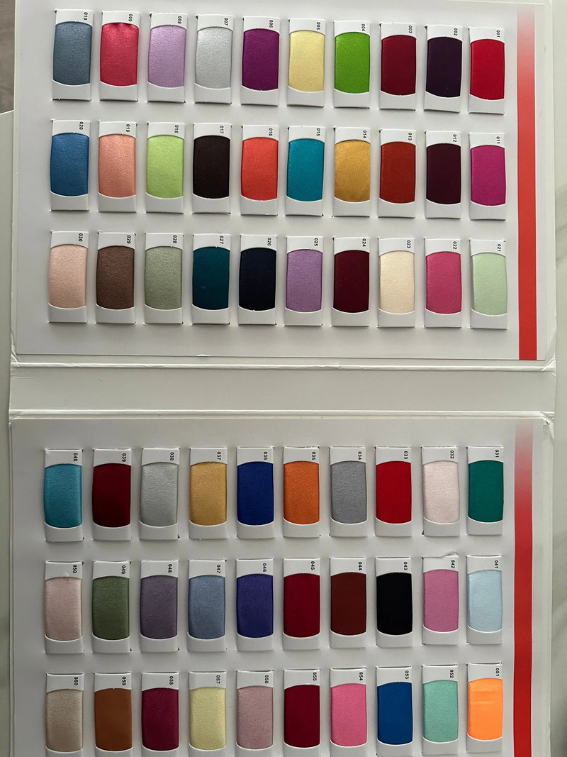 A variety of colorful fabric swatches arranged in rows for bridal and evening wear.