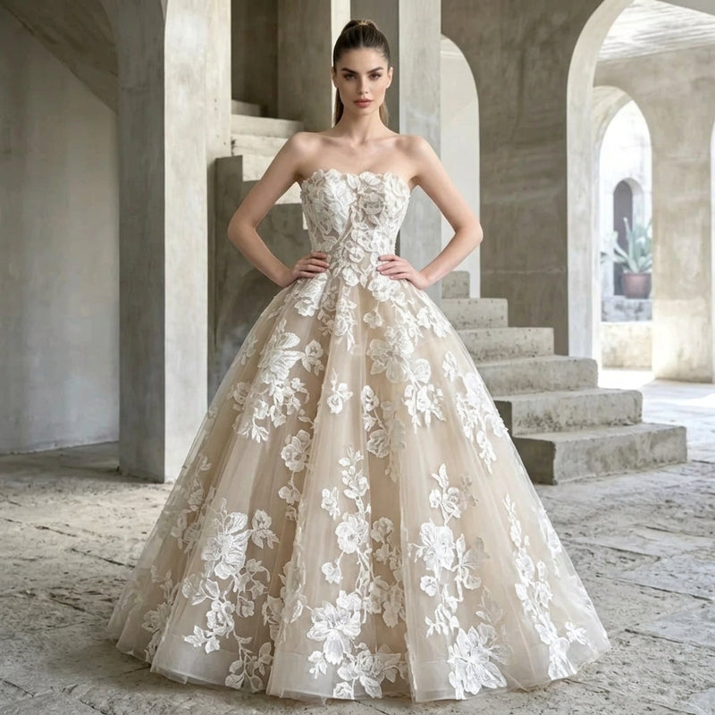 Woman wearing a strapless floral applique A-line bridal gown by AliExpress in a stone archway.