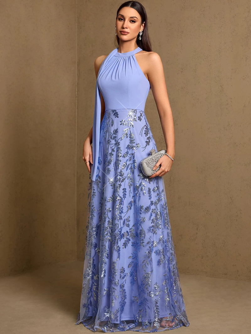 Woman wearing a Dream Designs Boutique shimmering blue sequined fit-and-flare evening gown.