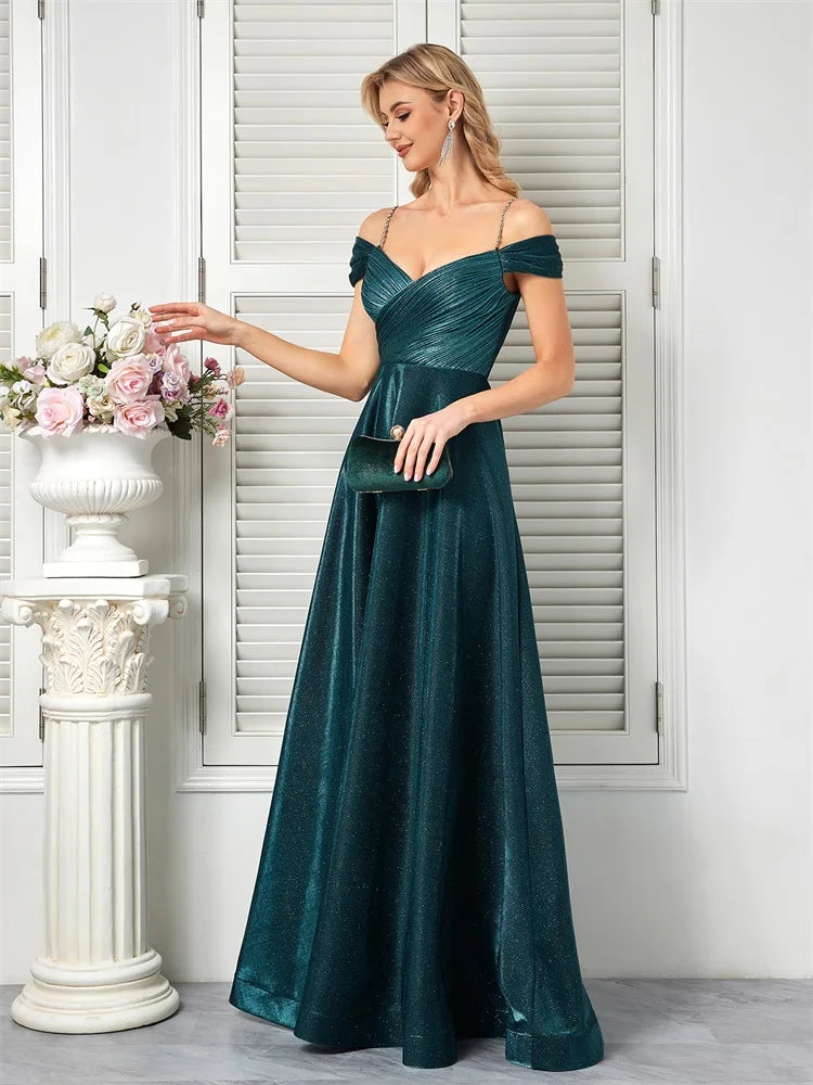 Woman in a sparkly beaded A-line evening gown with an open back in teal green.