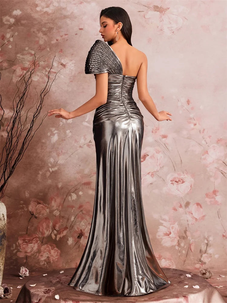 Woman in a metallic silver AliExpress one-shoulder mermaid gown with sculptural pleating.
