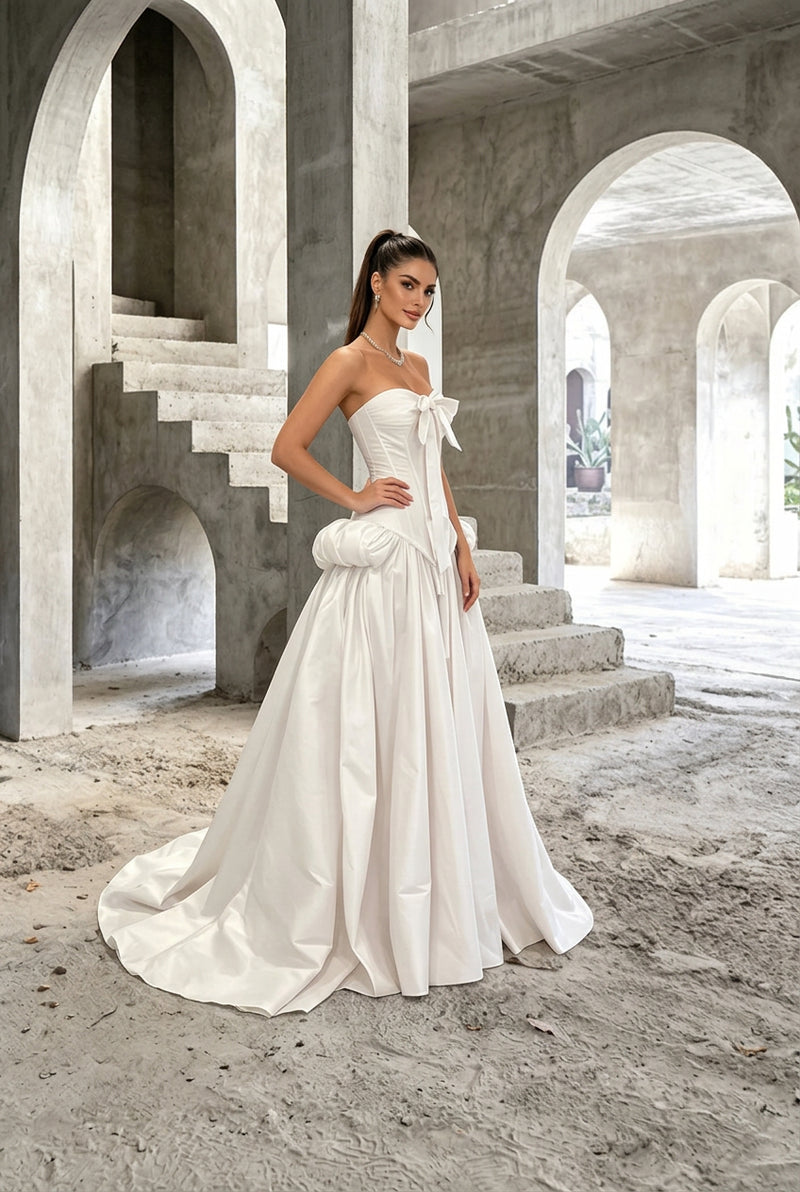 Model wearing an AliExpress strapless corset style white wedding gown with a train.