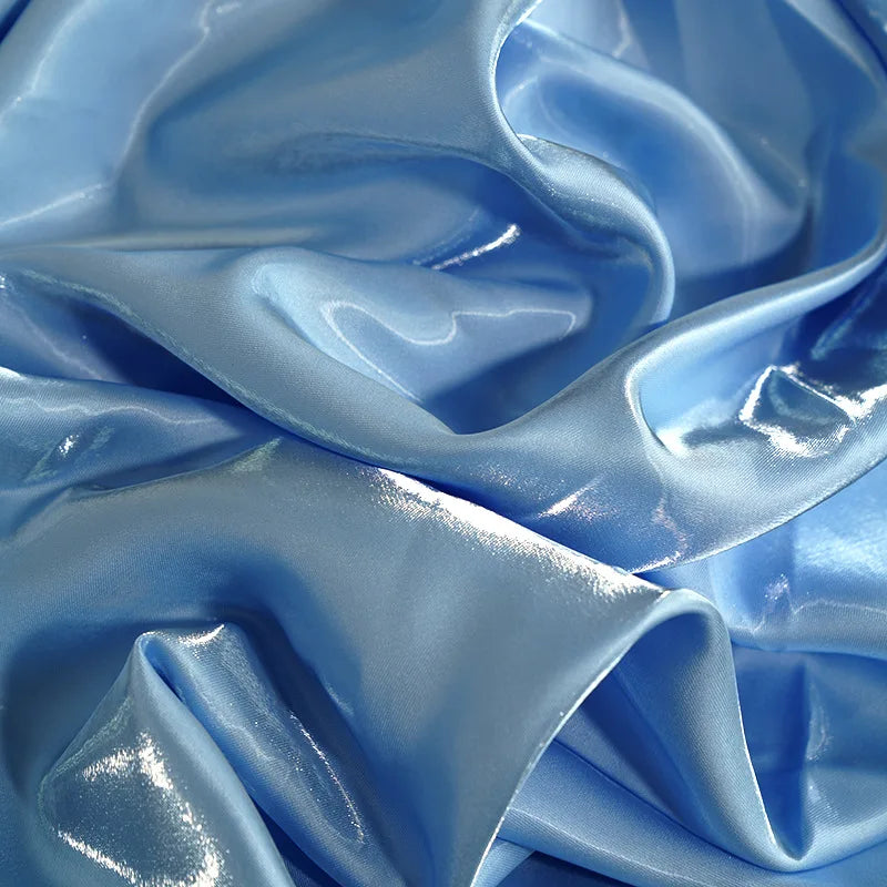 Shimmering light blue satin fabric texture for an elegant evening gown.