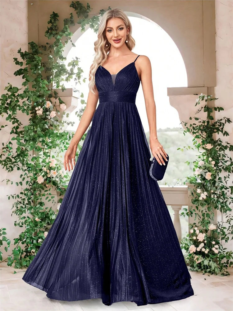Woman wearing an elegant deep V-neck navy blue chiffon A-line evening gown by Dream Designs Boutique