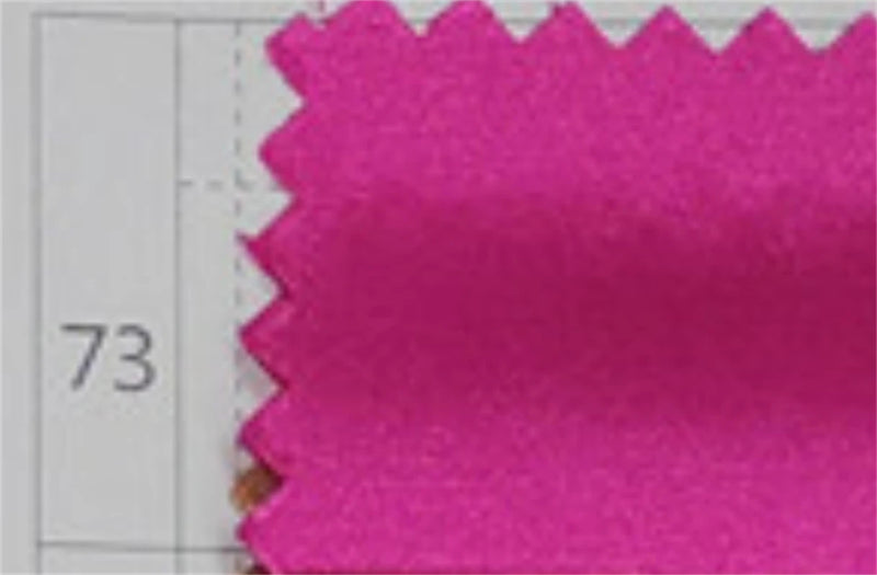 Bright pink fabric swatch with zigzag cut edges for evening wear.
