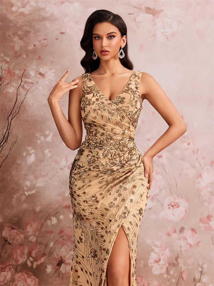 Woman wearing a Dream Designs Boutique gold sequined V-neck mermaid evening gown with a side slit.