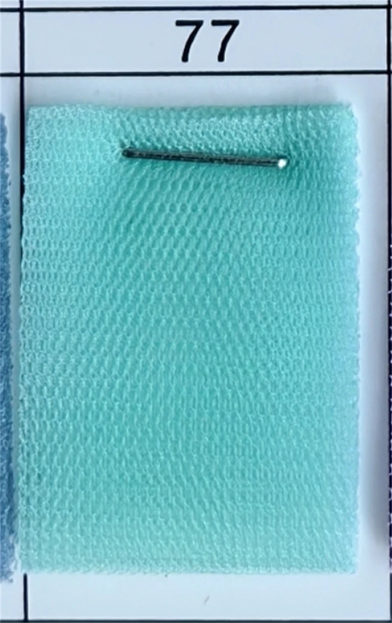Close-up of a light turquoise fabric swatch from AliExpress, labeled number 77.