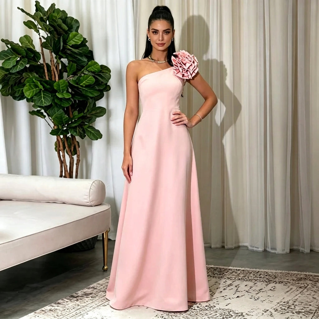 Woman wearing an AliExpress one shoulder pink A-line evening gown with 3D flower detail.