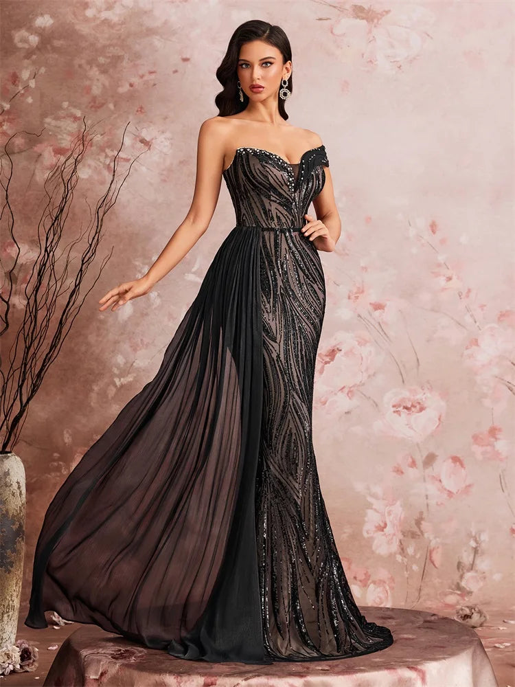 Woman wearing an off-the-shoulder sequined mermaid evening gown by Dream Designs Boutique