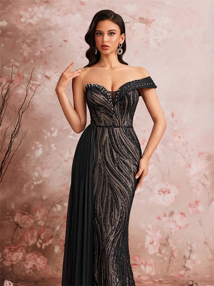 Dream Designs Boutique off-the-shoulder sequined mermaid evening gown in black.