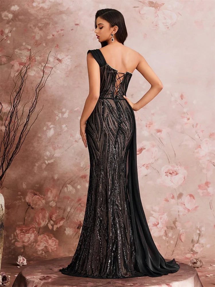 Back view of a woman in a Dream Designs Boutique off-the-shoulder sequined mermaid evening gown.