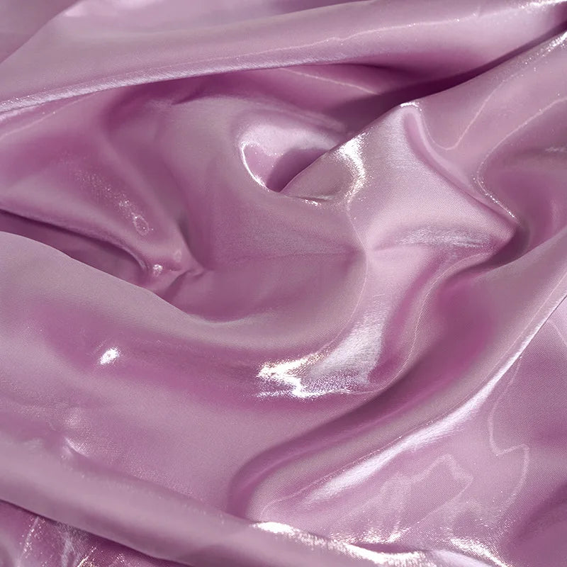 Shimmering lavender satin fabric texture for an elegant evening gown.
