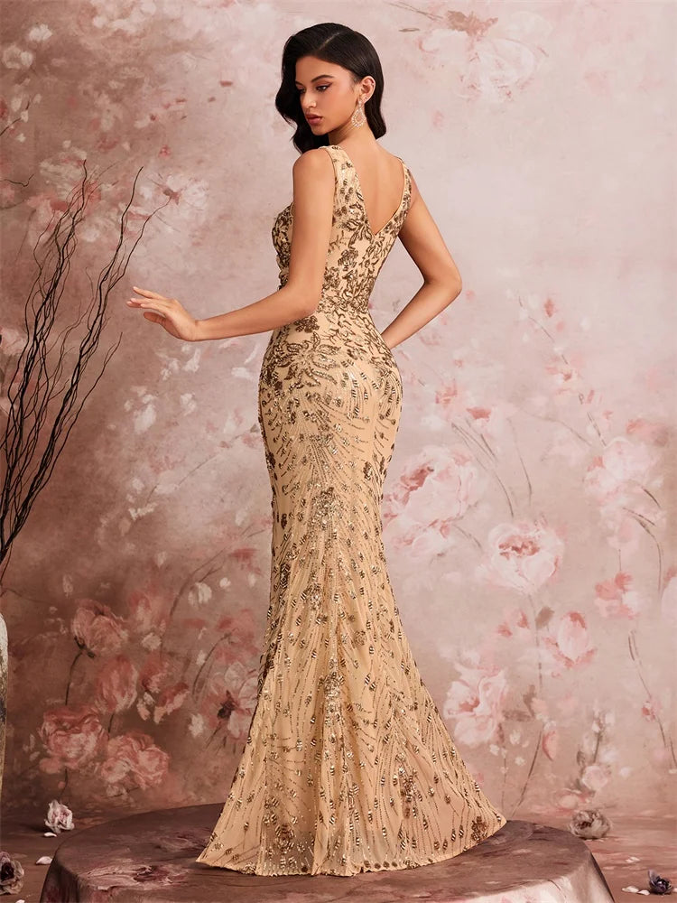 Woman wearing a Dream Designs Boutique gold sequined v-neck mermaid evening gown.