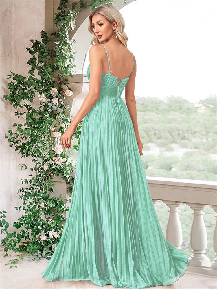 Woman in a mint green chiffon A-line evening gown with a deep V-neck by Dream Designs Boutique