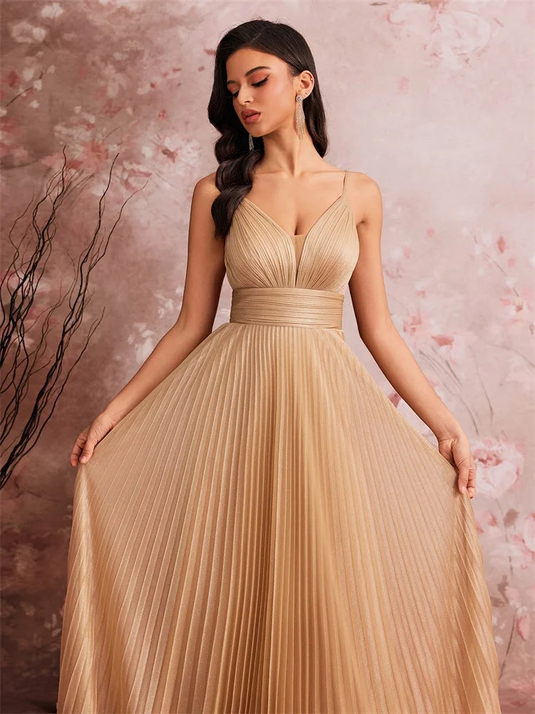 Woman wearing an elegant deep V-neck chiffon A-line evening gown in champagne gold.