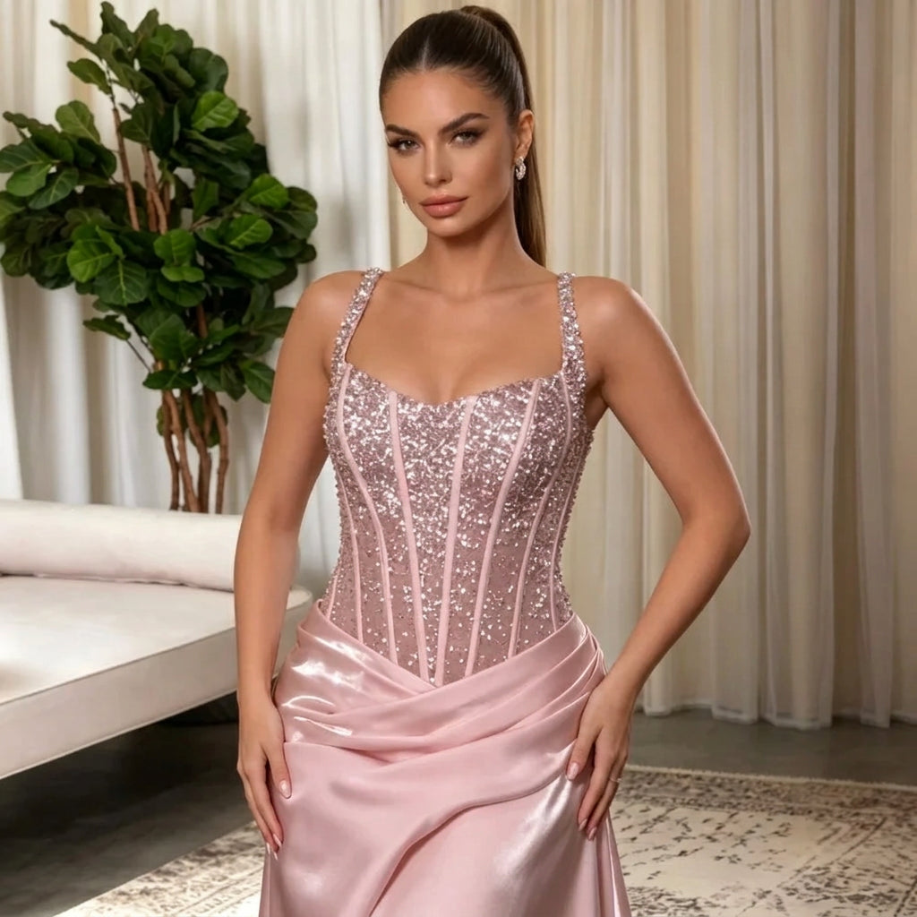 Woman wearing a pink AliExpress spaghetti strap corset satin evening gown.