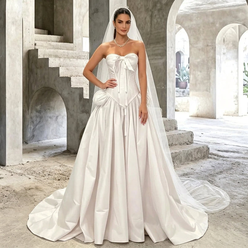 Woman wearing a white strapless corset wedding gown with a train and veil by AliExpress.