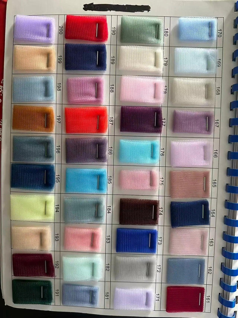 Color swatch palette of various tulle fabrics for bridal and evening wear.