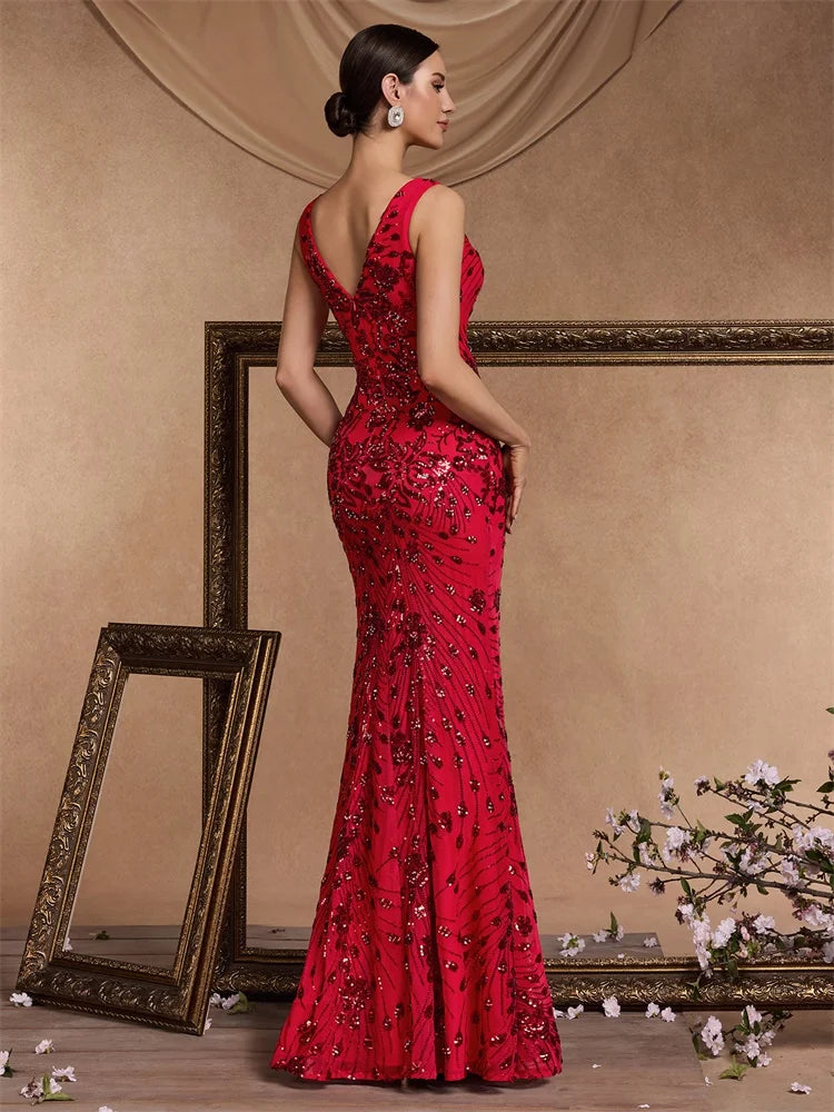 Woman in a red sequined V-neck mermaid evening gown by Dream Designs Boutique
