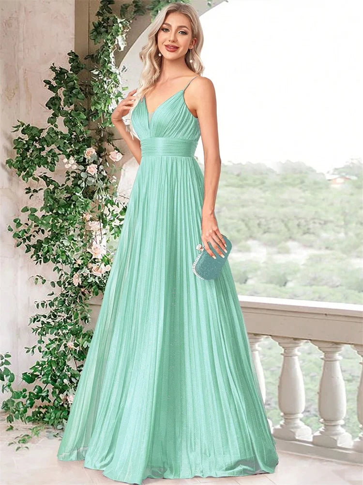 Woman in a mint green deep V-neck chiffon A-line evening gown by Dream Designs Boutique