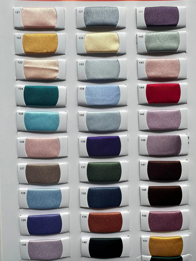 Assorted satin fabric swatches in various colors including ivory, gold, blue, and burgundy.