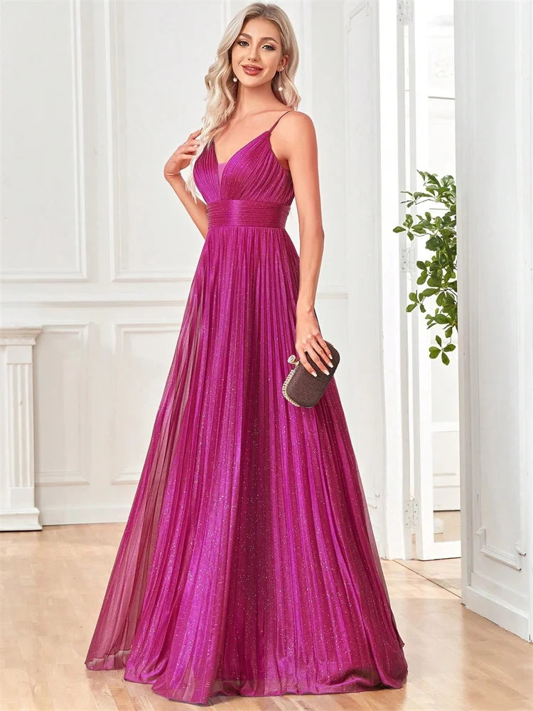 Woman in Dream Designs Boutique magenta chiffon A-line evening gown with deep V-neck.