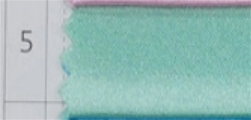Close-up of light teal and pink fabric swatches.
