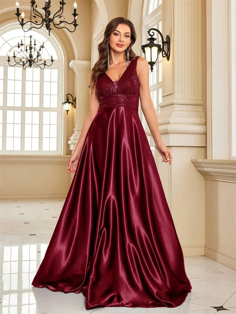 Woman wearing a Dream Designs Boutique sequined V-neck A-line burgundy evening gown.
