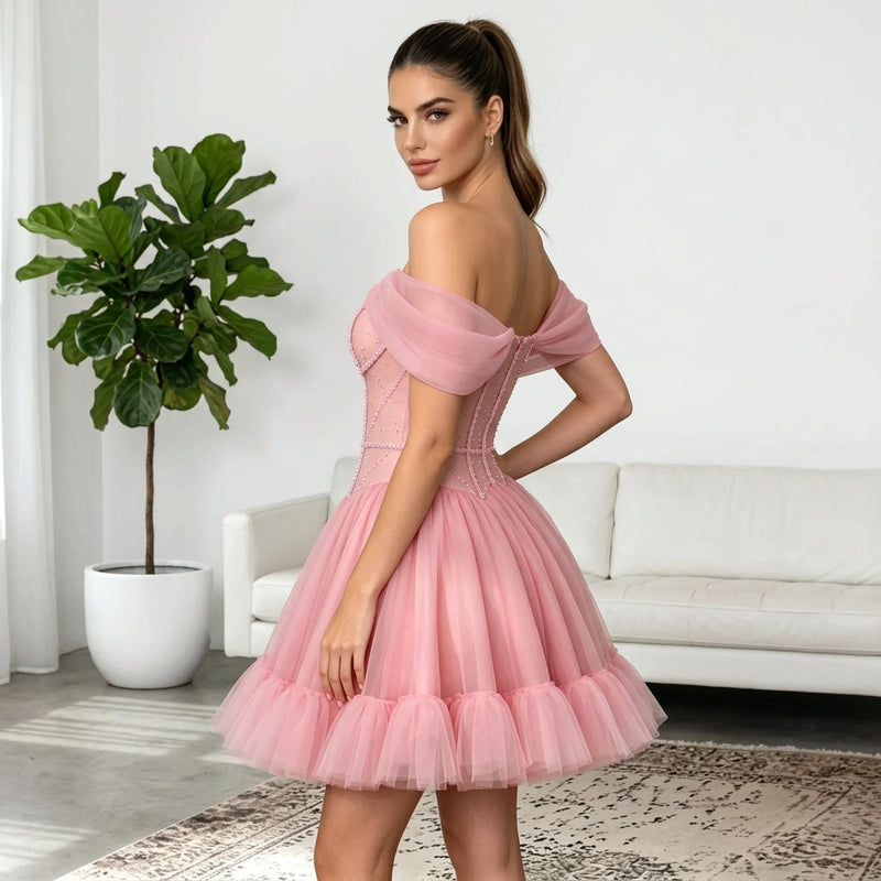 Woman wearing an AliExpress off the shoulder pink short formal mini tulle dress