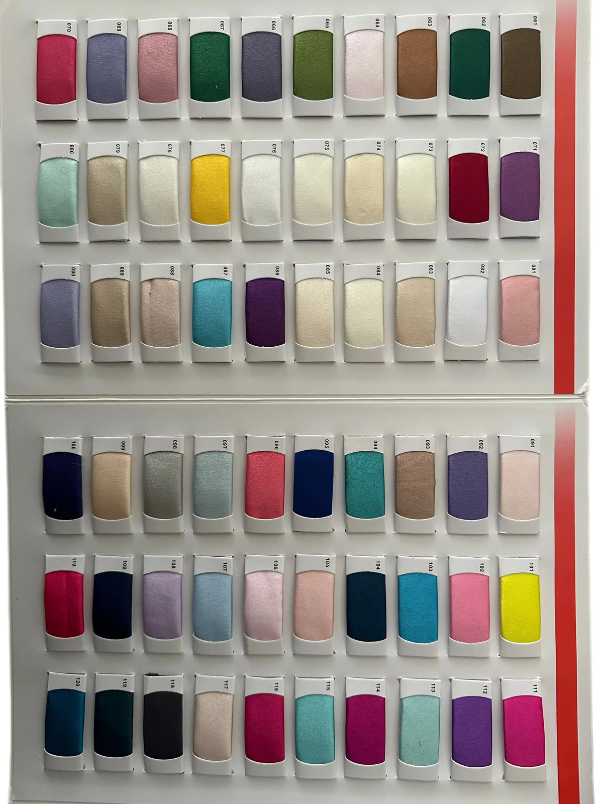 A wide variety of colorful fabric swatches arranged in rows for dress selection.