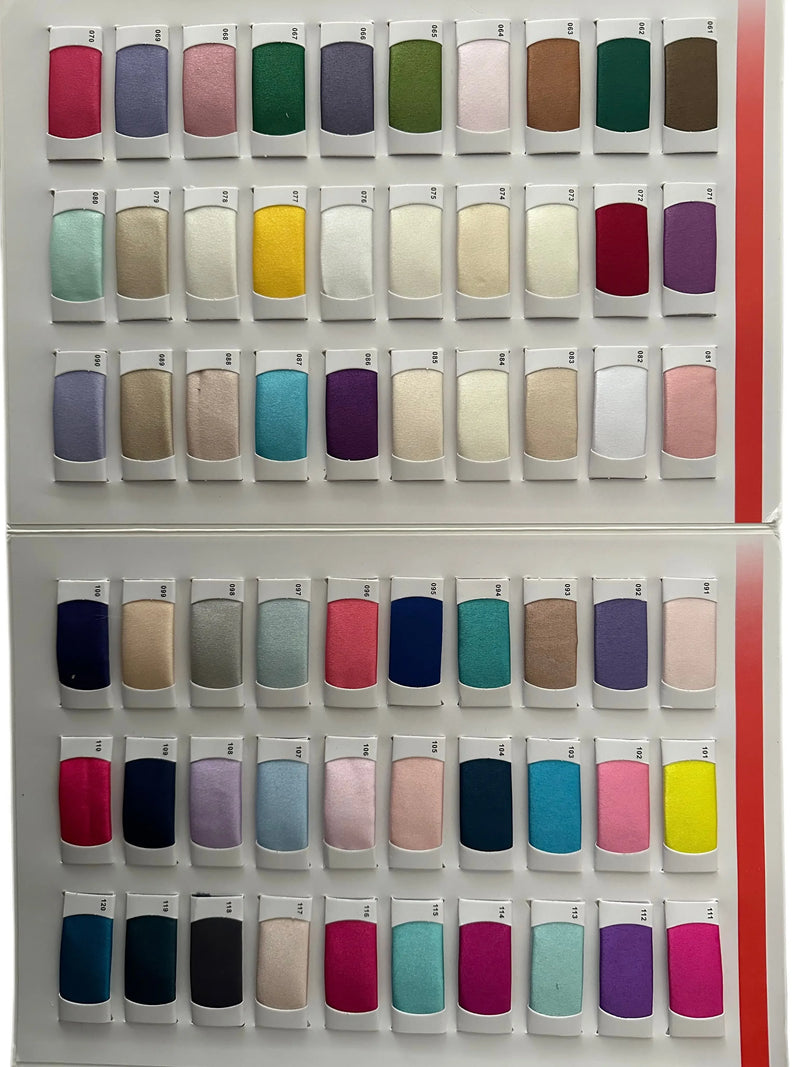 A wide variety of colorful fabric swatches arranged in rows for dress selection.
