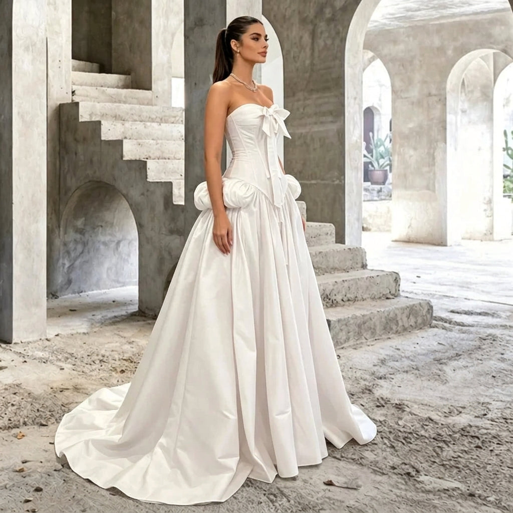 AliExpress strapless corset style white wedding gown with a train in a concrete setting