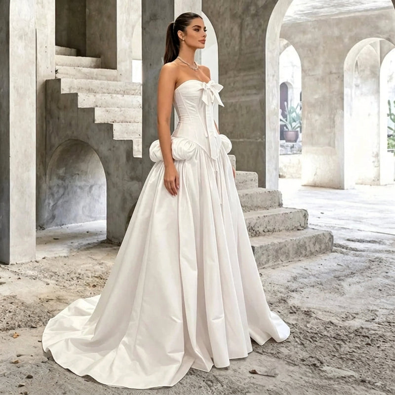 AliExpress strapless corset style white wedding gown with a train in a concrete setting