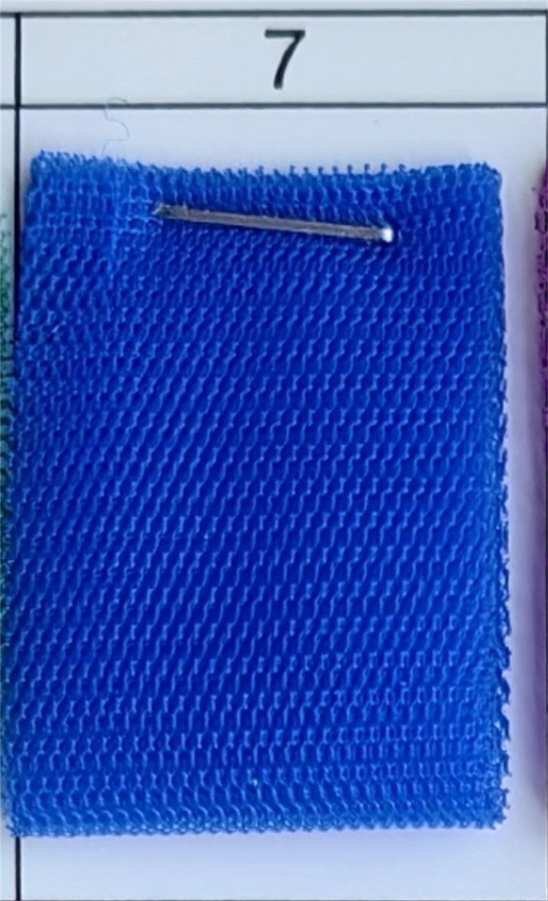 Close-up of a blue textured fabric swatch from AliExpress with a silver pin.