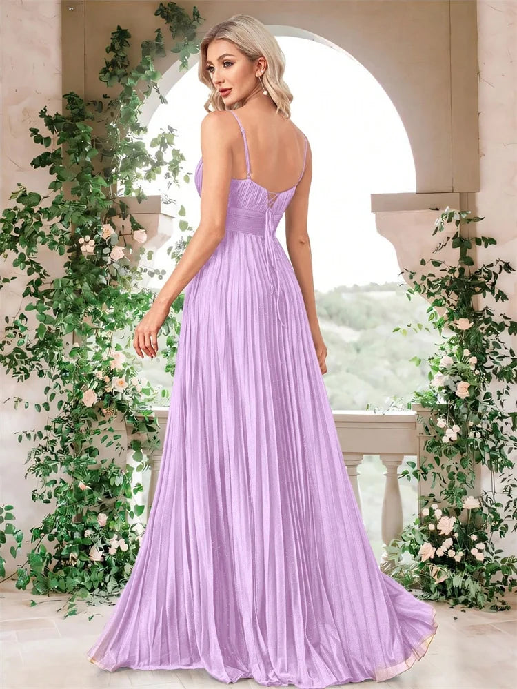 Back view of a woman wearing a lavender chiffon A-line evening gown by Dream Designs Boutique.