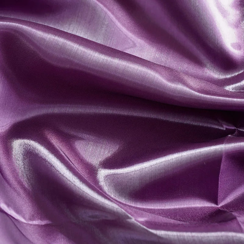 Shiny purple satin fabric texture with elegant folds for evening gowns.