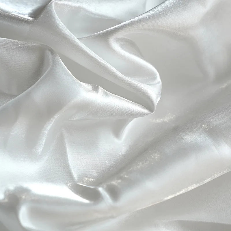 Elegant white satin fabric with soft flowing folds and a glossy sheen.