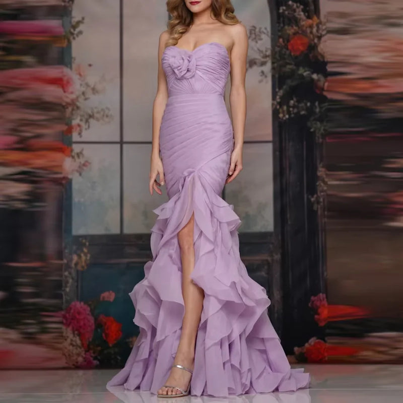 Woman wearing a Pink Strapless Organza Mermaid Gown with tiered floral detail by Dream Designs Boutique