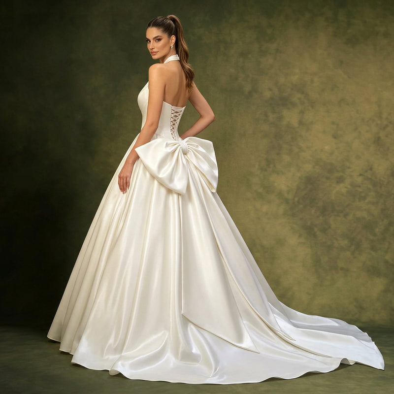 Woman wearing a strapless pleated satin bridal gown by AliExpress with a large back bow.